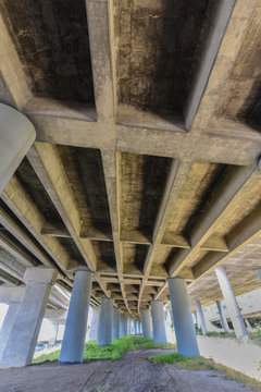 Freeway Underpass With Pillars And Grass