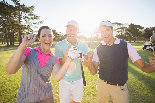 Portrait of cheerful golfer friends 