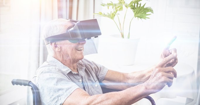 Senior Man In A Wheelchair Using A Virtual Reality Device