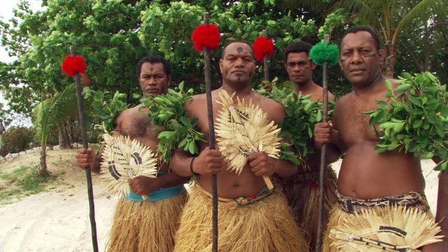 Male Fijian ceremonial dancers posing for portrait