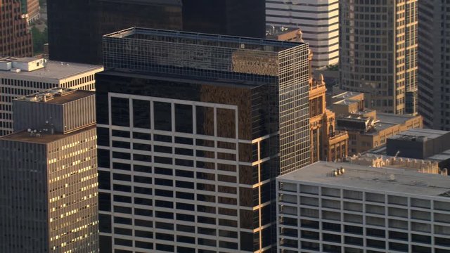 Close flight past layered Houston skyscrapers to Gulf Building. Shot in 2008.