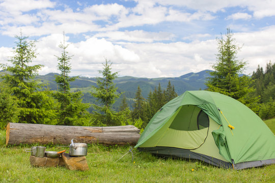 Camping in a mountainous area with cooking equipment.