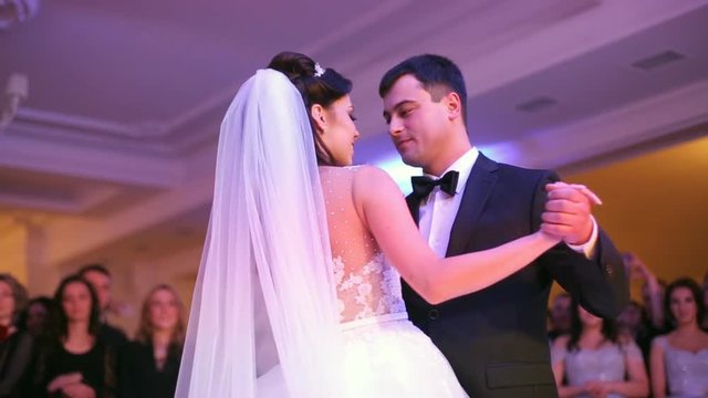 Beautiful bride and handsome groom dancing first dance at the wedding party