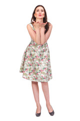 Air kiss. Adult woman posing in bright summer dress, isolated on