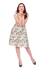 Air kiss. Adult woman posing in bright summer dress, isolated on