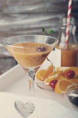 Orange cocktail with ice in a glass