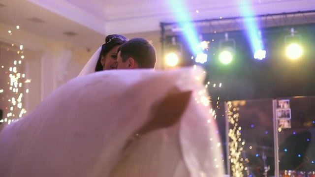Beautiful bride and handsome groom dancing first dance at the wedding party