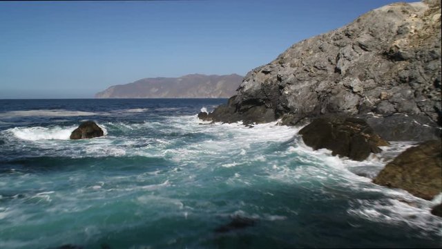 Past cliffs and surf-splashed rocks along the Catalina coastline. Shot in 2010.