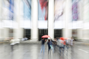 Blurred pedestrian in the city, zoom effect, motion blur