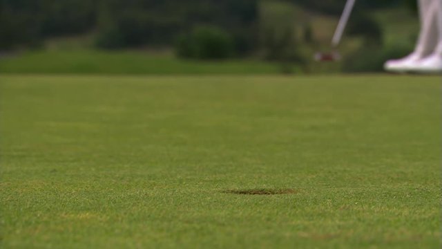 Close-up of successful putt