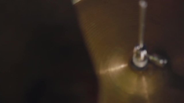Man drummer energetically plays rock music close-up handle shot