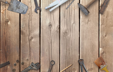 Old construction tools with free space for text. Hammer, chisel, brush, paint, wood plane, ruler, shavings, jointer, nail, wrench.