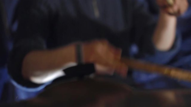 Man drummer energetically plays rock music hands close-up handle shot