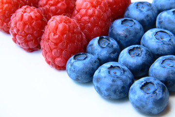 closeup of a bunch of raspberries and blueberries