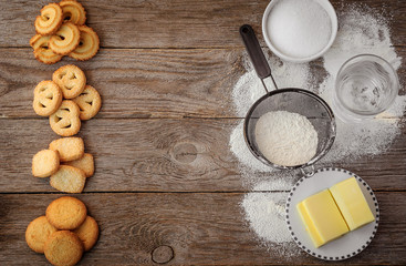 butter cookies with ingredients on a wooden surface.