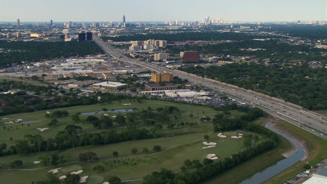 Wide aerial approach across freeway toward downtown Houston. Shot in 2007.