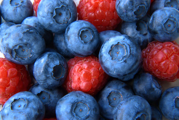 closeup of a bunch of raspberries and blueberries