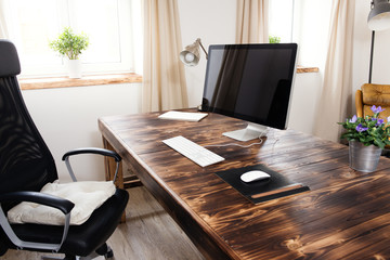 Home office with wooden table and computer - obrazy, fototapety, plakaty