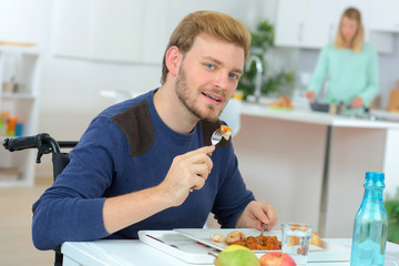 Disabled man having his lunch