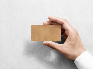 Hand hold blank plain kraft business card design mockup. Clear calling card mock up template...