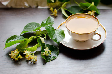 porcelain Cup of Linden tea on a background of dark wood