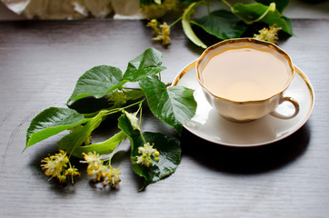 porcelain Cup of Linden tea on a background of dark wood