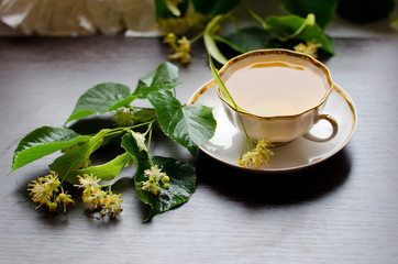 porcelain Cup of Linden tea on a background of dark wood