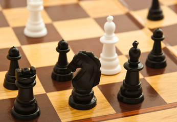 black and white chess figures on a chessboard