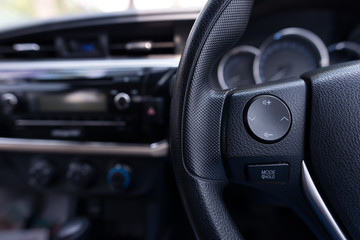 Fototapeta na wymiar Audio control buttons on the steering wheel of a modern car