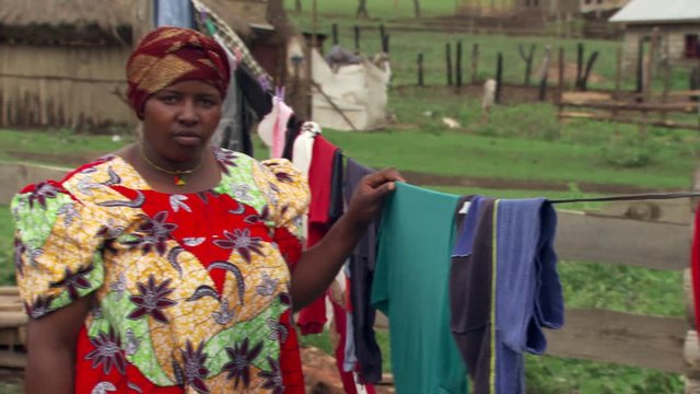 Tanzanian housewife posing beside clothesline