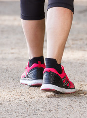 Elderly senior woman walking on hiking trail, sporty lifestyles in old age