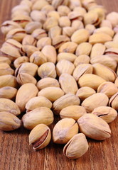 Pistachio nuts on wooden table, healthy eating