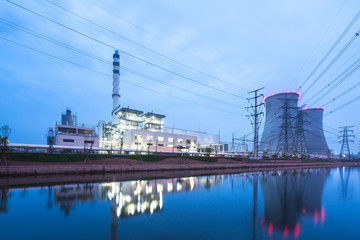 Fototapeta na wymiar modern power station near river at twilight