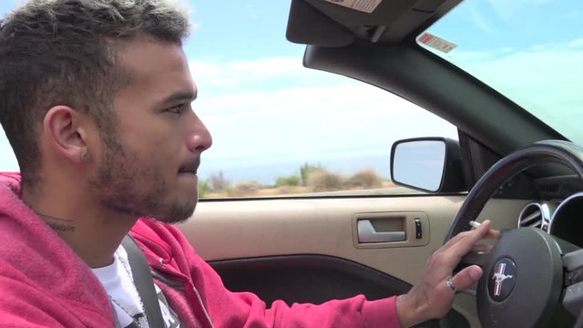 Handsome Young Man Driving A Convertible Car
