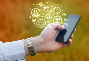 Hand holding smartphone with mobile app choices