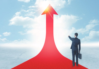 businessman standing on a red arrow