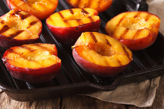 Ripe peaches on a a grill pan close-up. Horizontal
