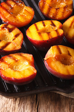 Ripe peaches on a a grill pan close-up. vertical
