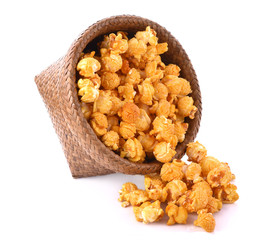 Caramel Popcorn in basket on white background