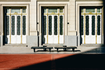 Three doors with two concrete benches and shadow