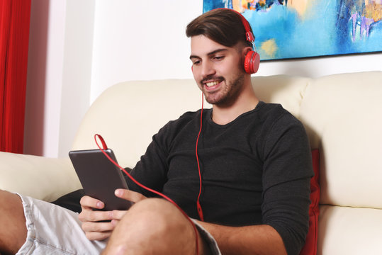 Young man listening to music with tablet