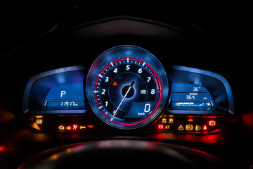 Modern car instrument dashboard panel or speedometer and full symbol in night time