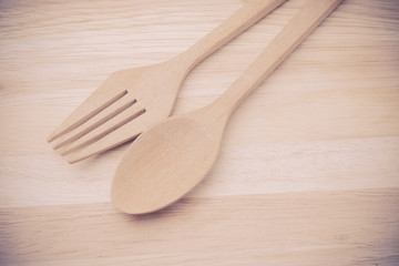 Wooden spoon on wood table with filter effect retro vintage styl