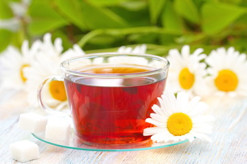 Cup of tea and daisy
