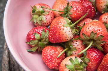 Small white filled with succulent juicy fresh ripe red strawberr