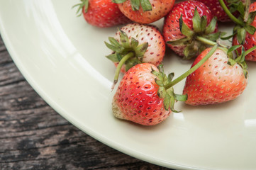 Small white filled with succulent juicy fresh ripe red strawberr