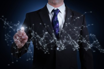 Composite image of businessman standing and pointing