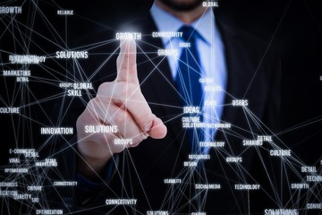 Composite image of businessman pointing his finger at camera