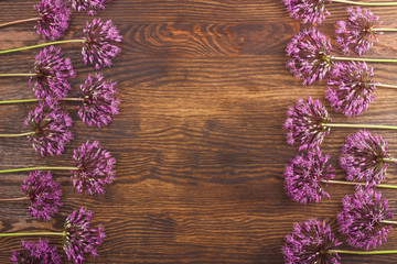 Violet flowers and a box on the wooden board