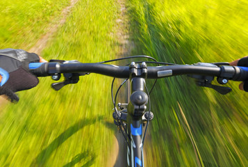 Fototapeta na wymiar Fast motion mountain bike on a grassy road